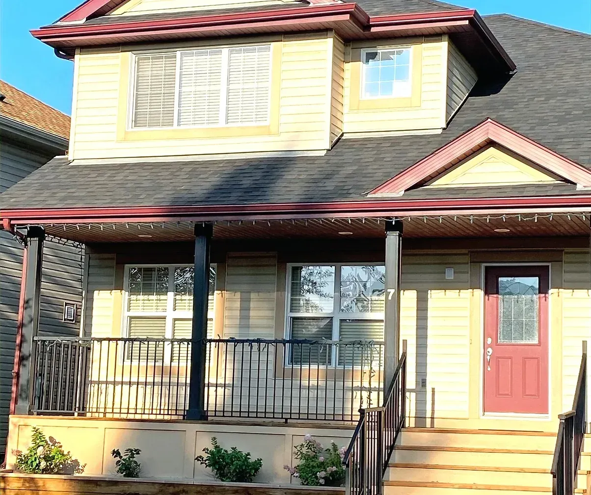 The front of a house with a porch and stairs