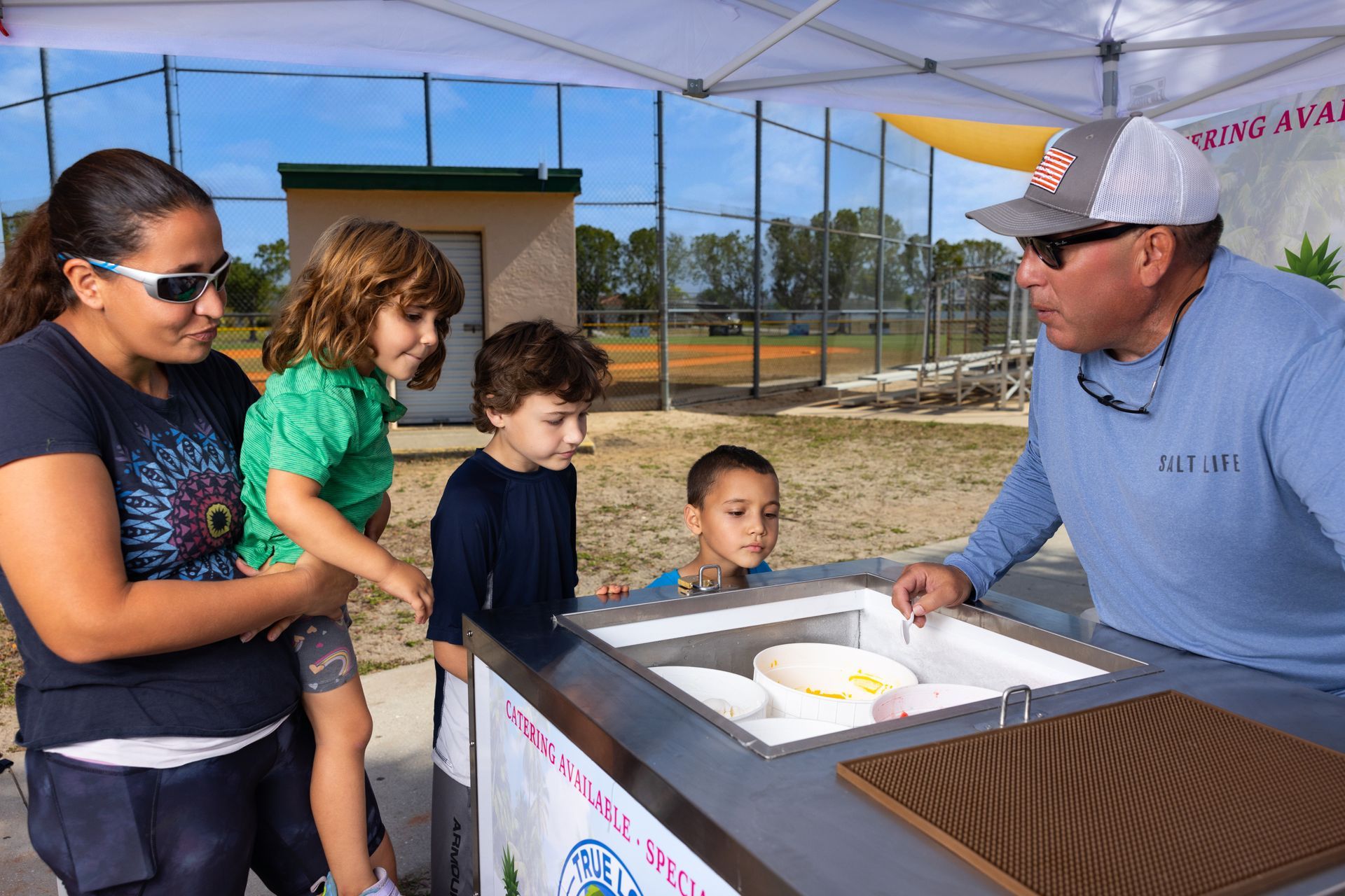 A man is serving ice cream to a family.
