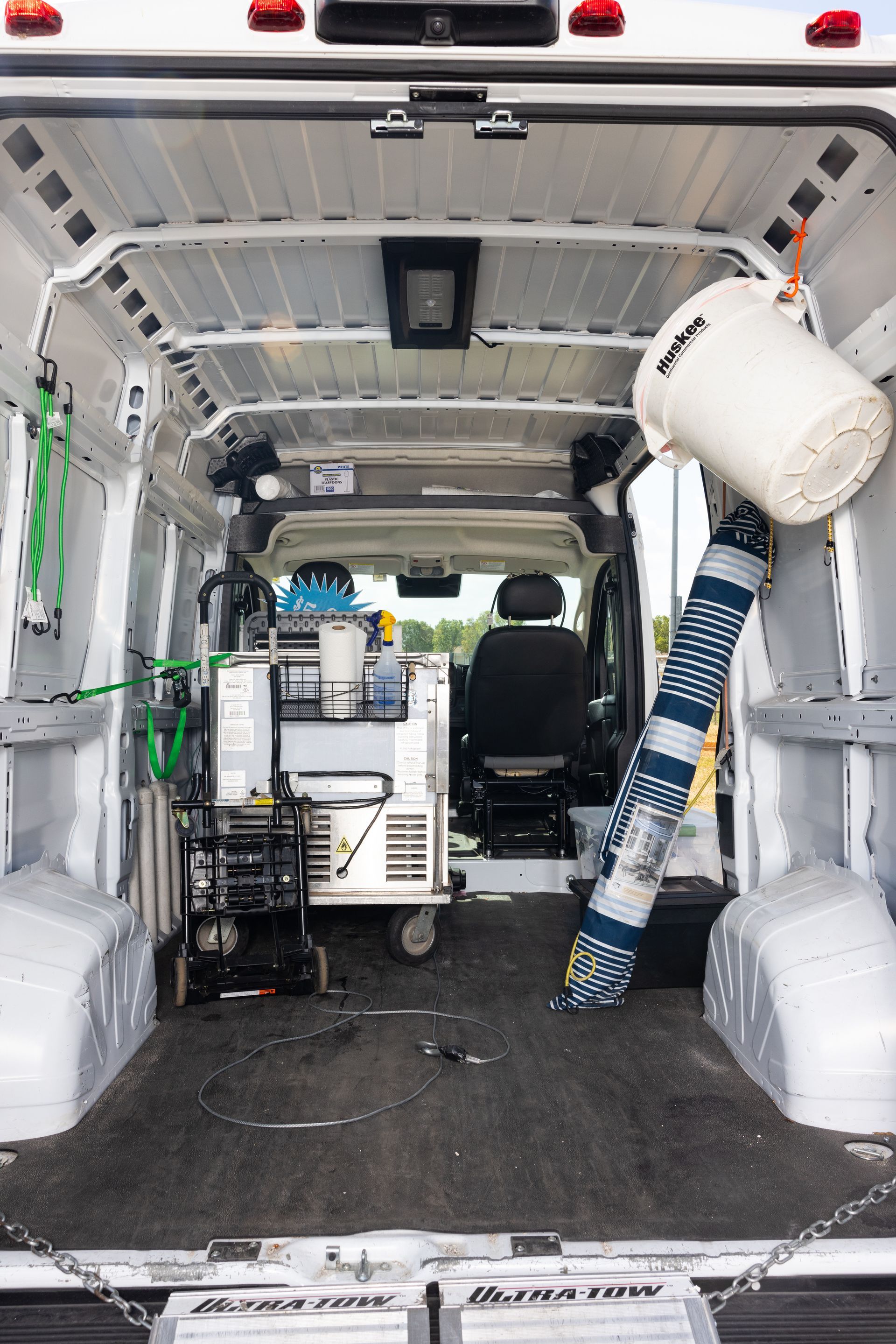 The inside of a white van with a lot of equipment in it.