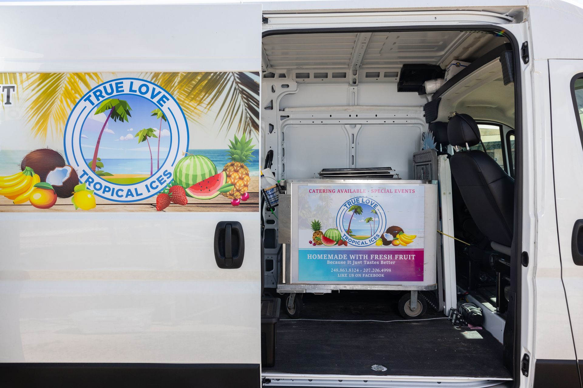 A white van with tropical ices written on the side