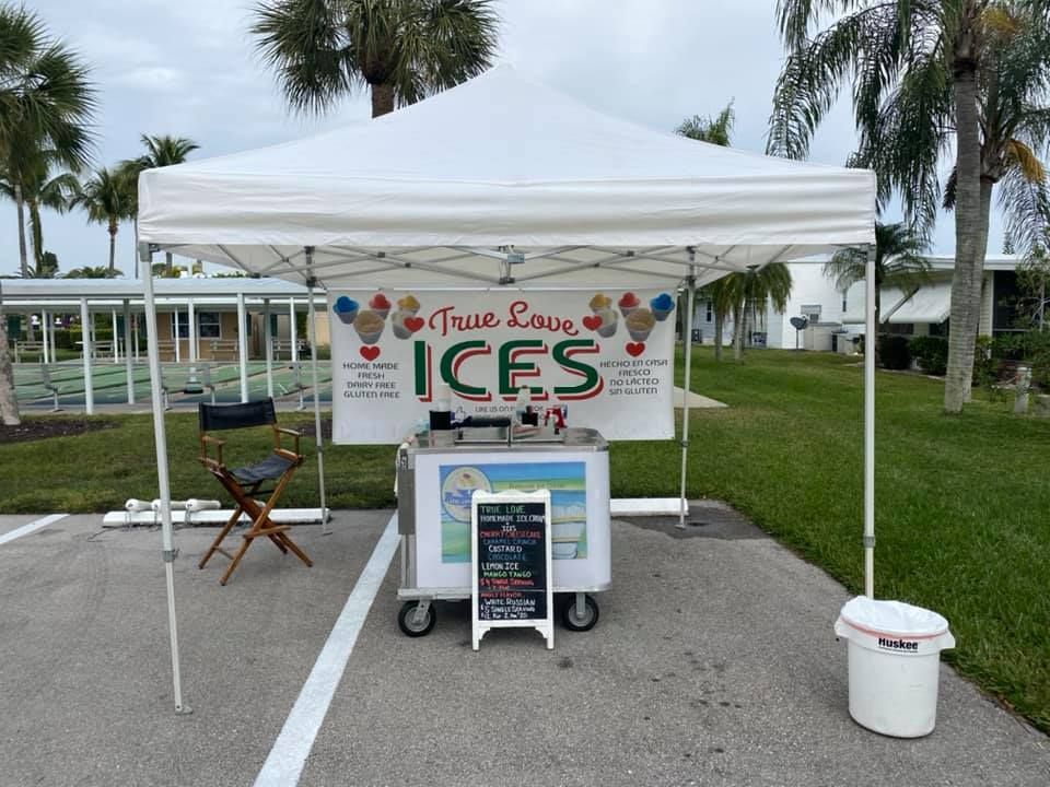 A white tent with a sign that says true love ices