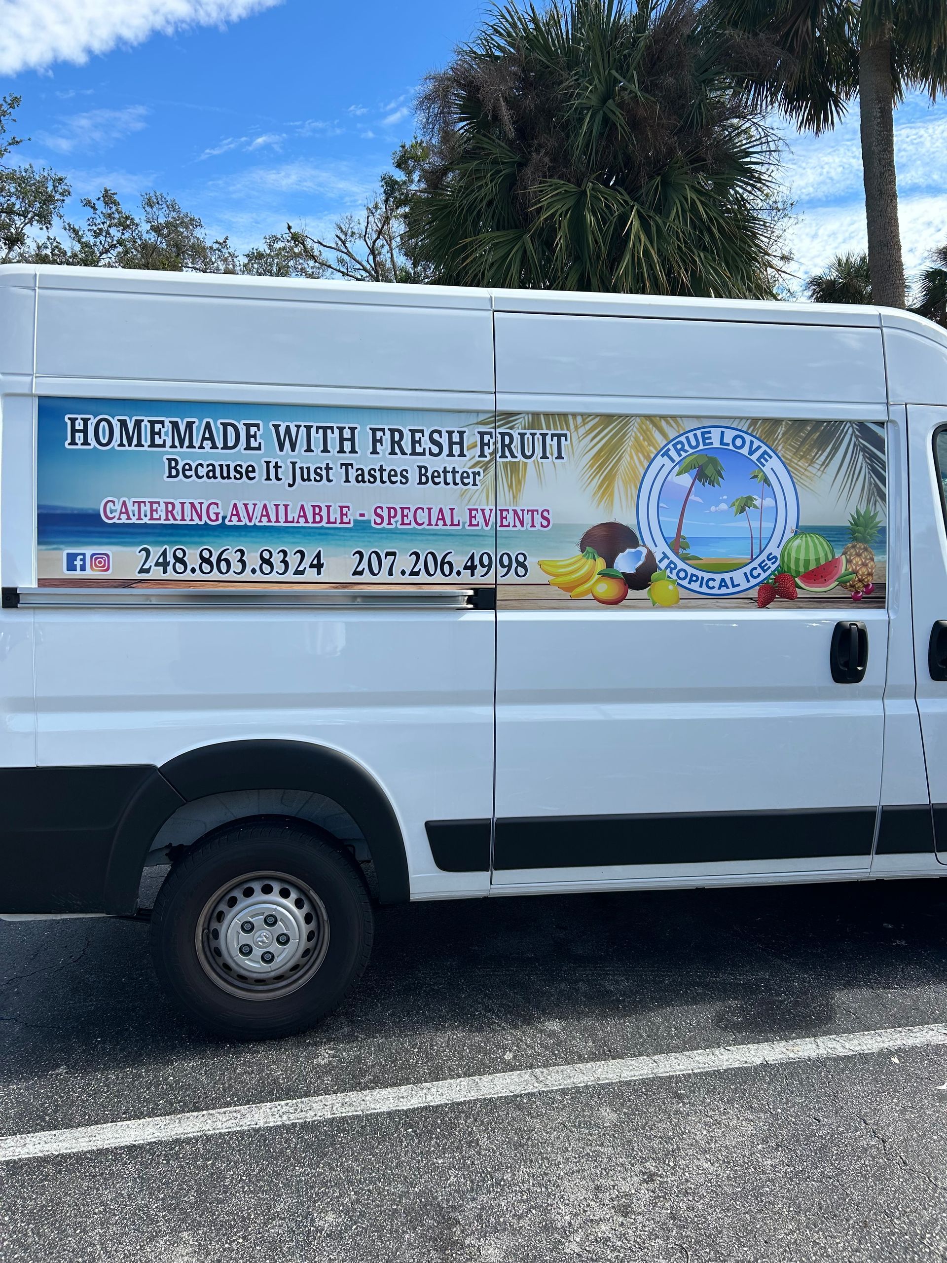 A white van is parked in a parking lot.