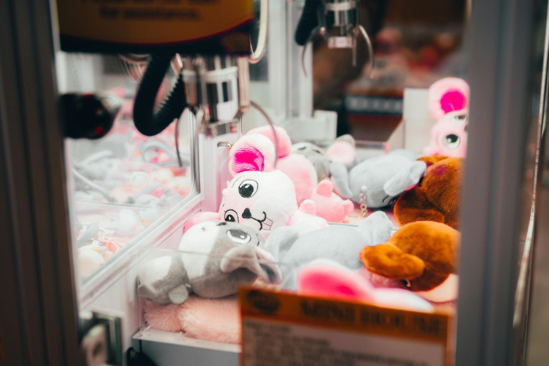 Claw machine filled with stuffed animals, including bunnies and bears.