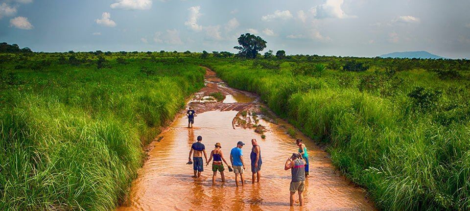 A Bunch Of People Standing In A Flooded 4x4 Track — Rainbow Beach Auto Electrics In Rainbow Beach, QLD