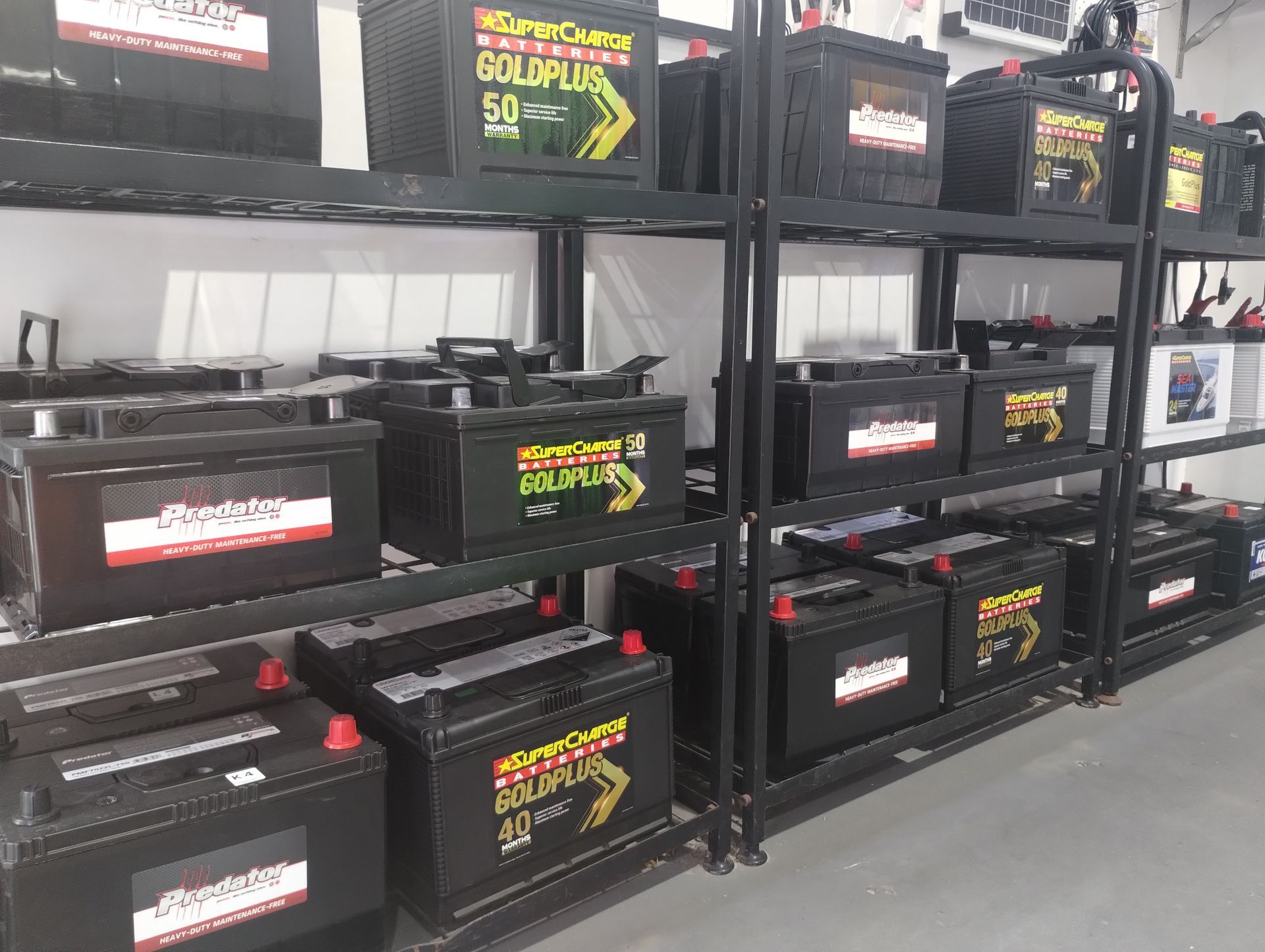 A Stack Of Batteries Sitting On A Shelf — Rainbow Beach Auto Electrics In Rainbow Beach, QLD