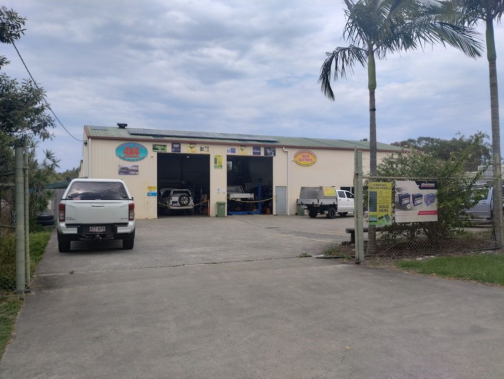 A White Truck Is Parked In Front Of A Garage — Rainbow Beach Auto Electrics In Rainbow Beach, QLD