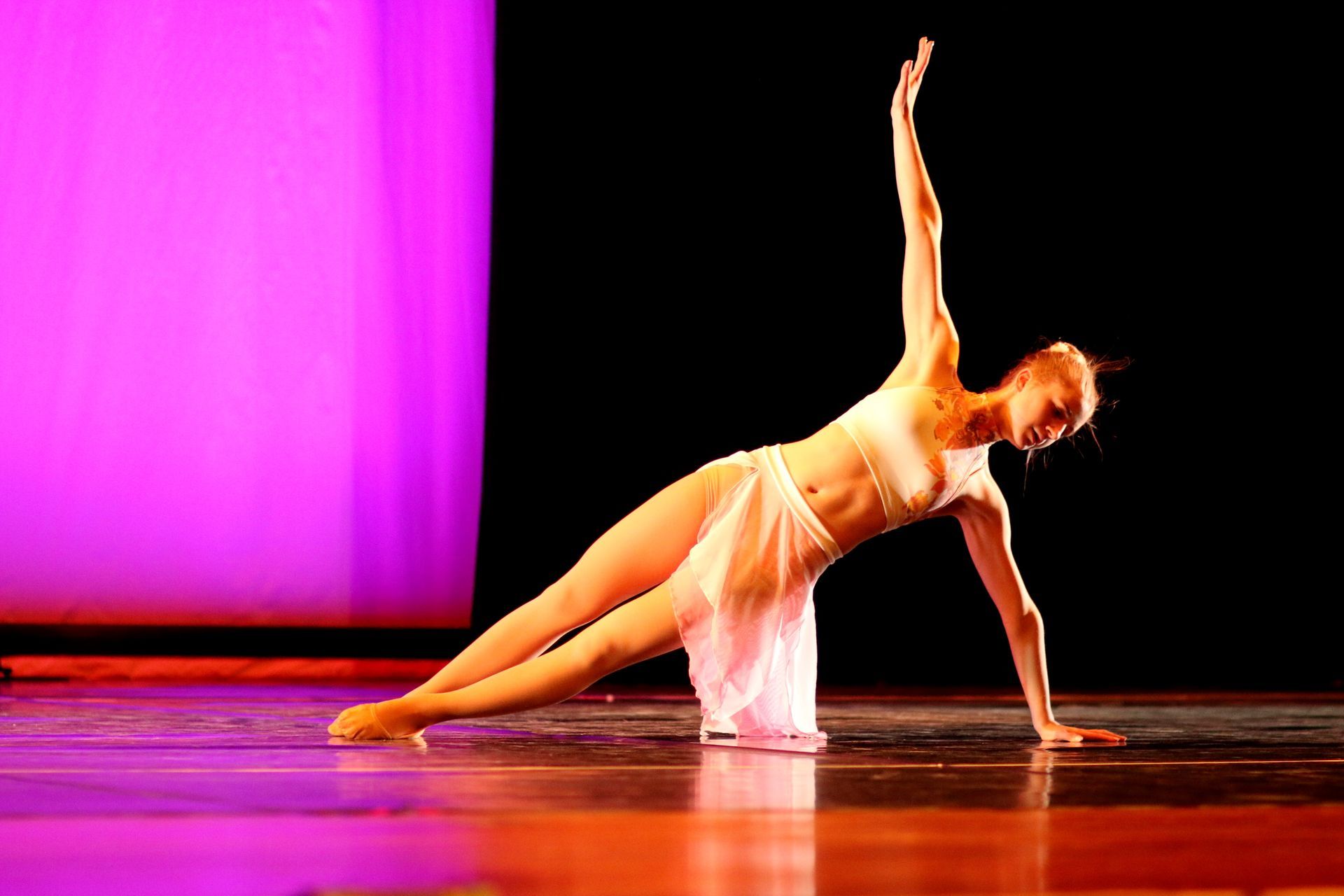 a woman is doing a plank on a stage .