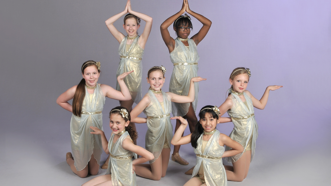a group of young girls are posing for a picture together .