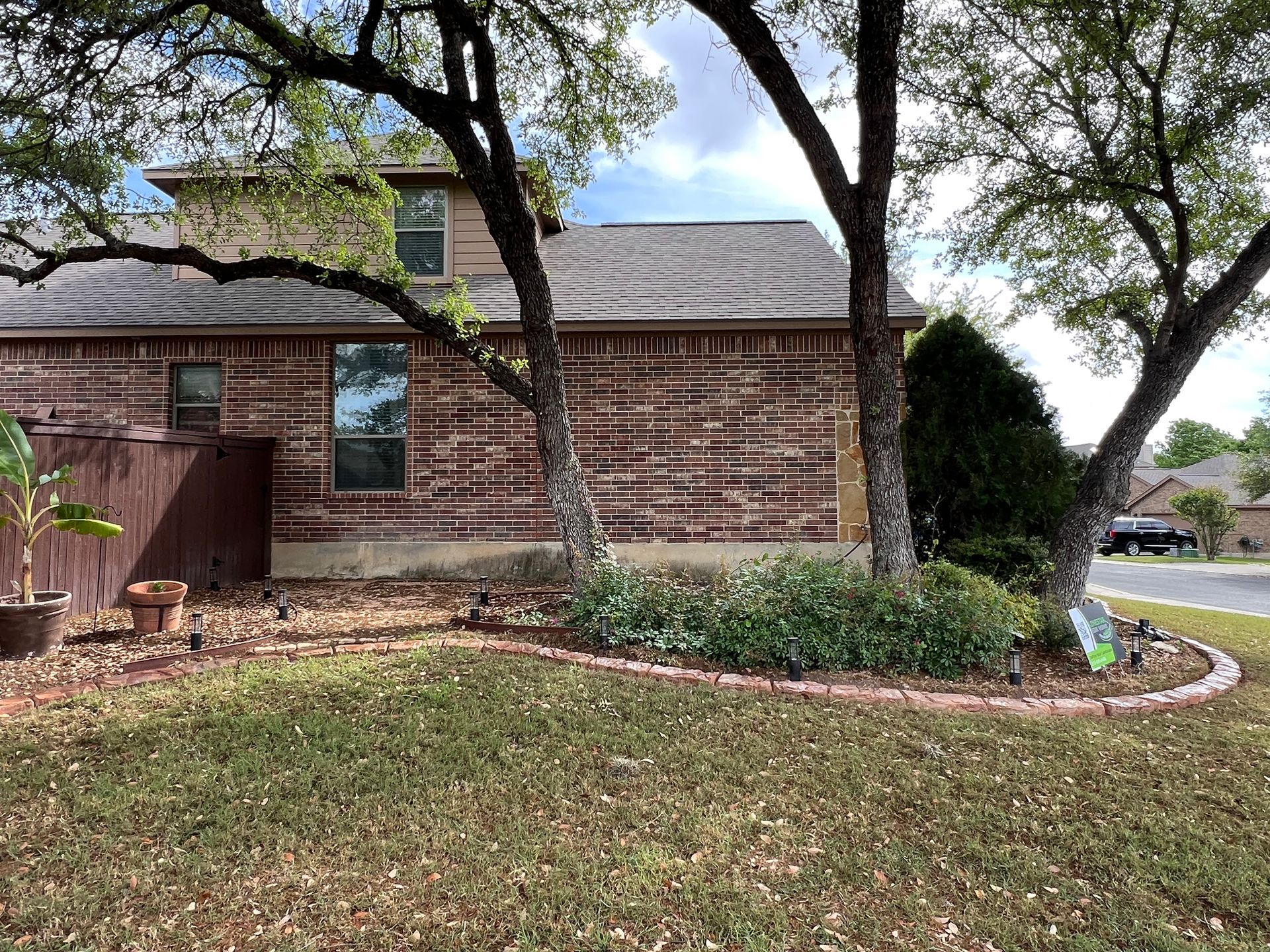 A log cabin is sitting on top of a lush green lawn.