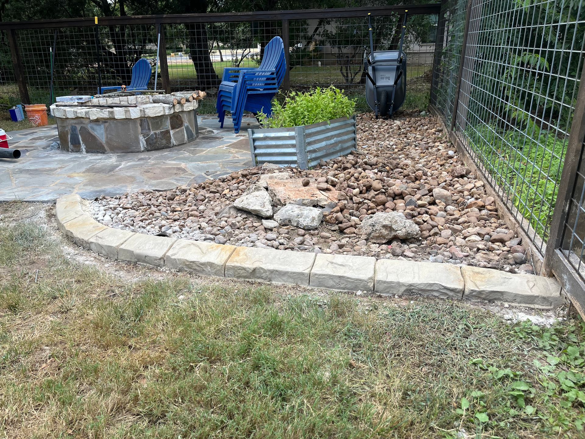 There is a fire pit in the middle of the yard.