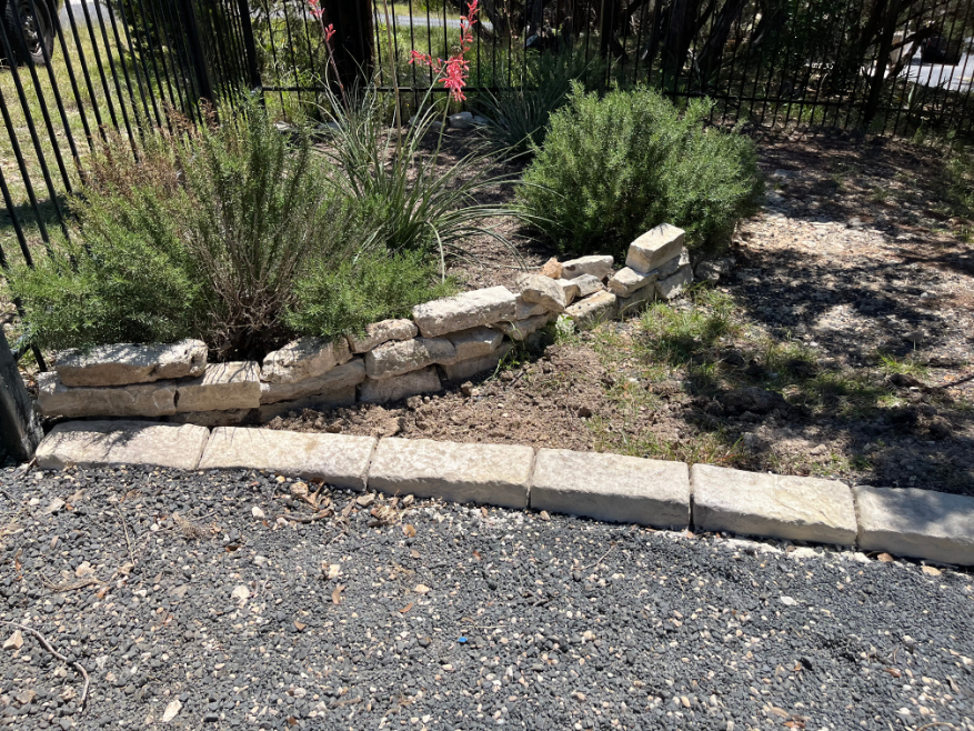 There is a stone wall in the middle of the road.