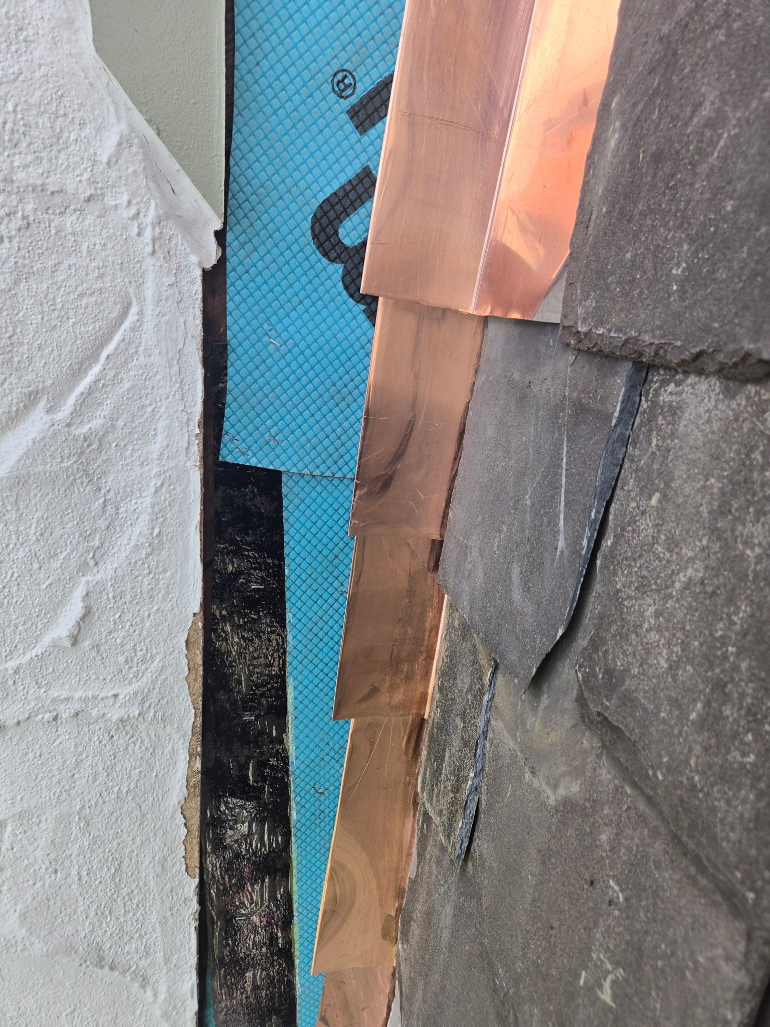 A close up of a piece of copper on a roof.
