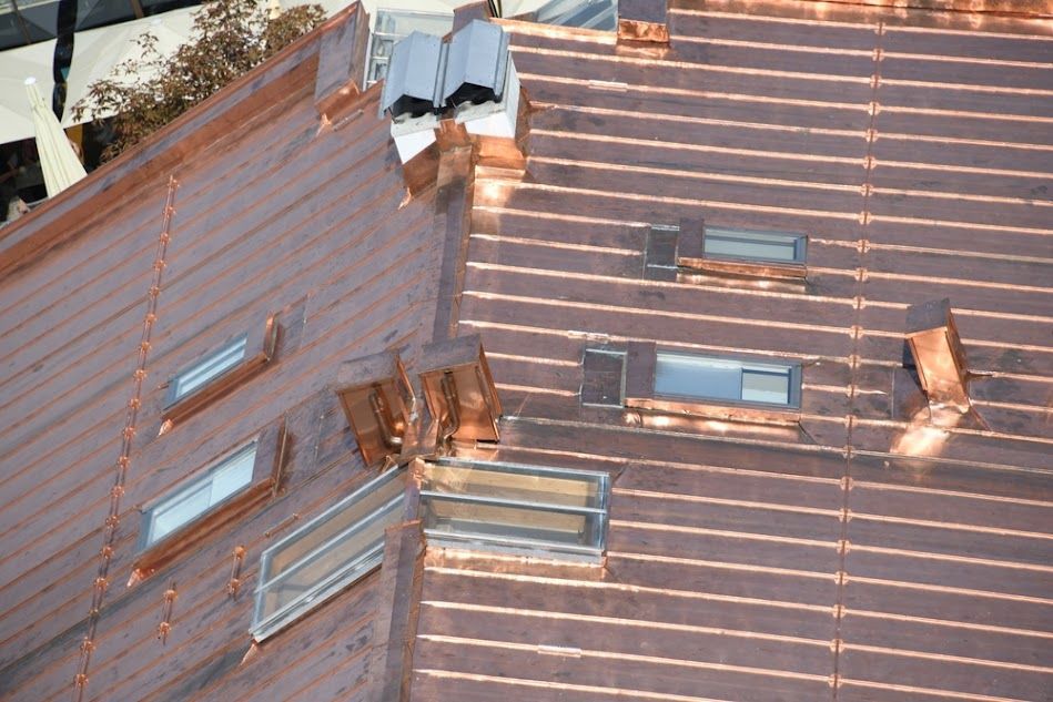 An aerial view of a building with a copper roof