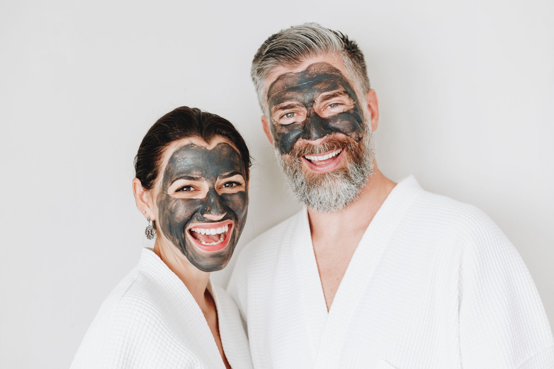 A man and a woman with black masks on their faces.