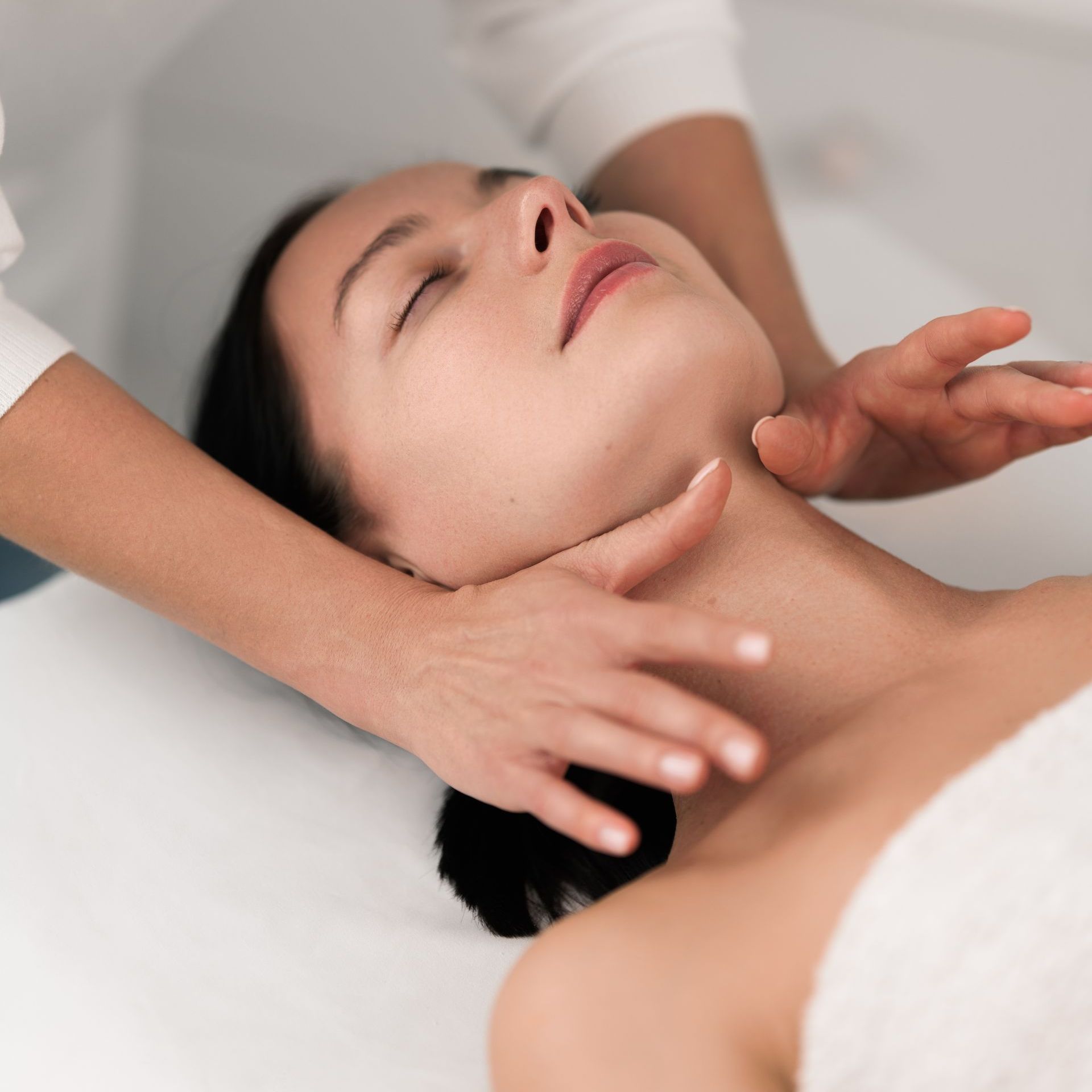 A man is getting a massage from a woman in a spa.