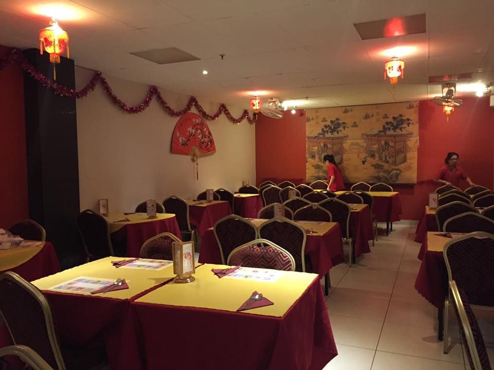 Tables and Chairs and a Fan on the Wall In a Restaurant — Red Lantern Chinese Restaurant In Palmerston City, NT