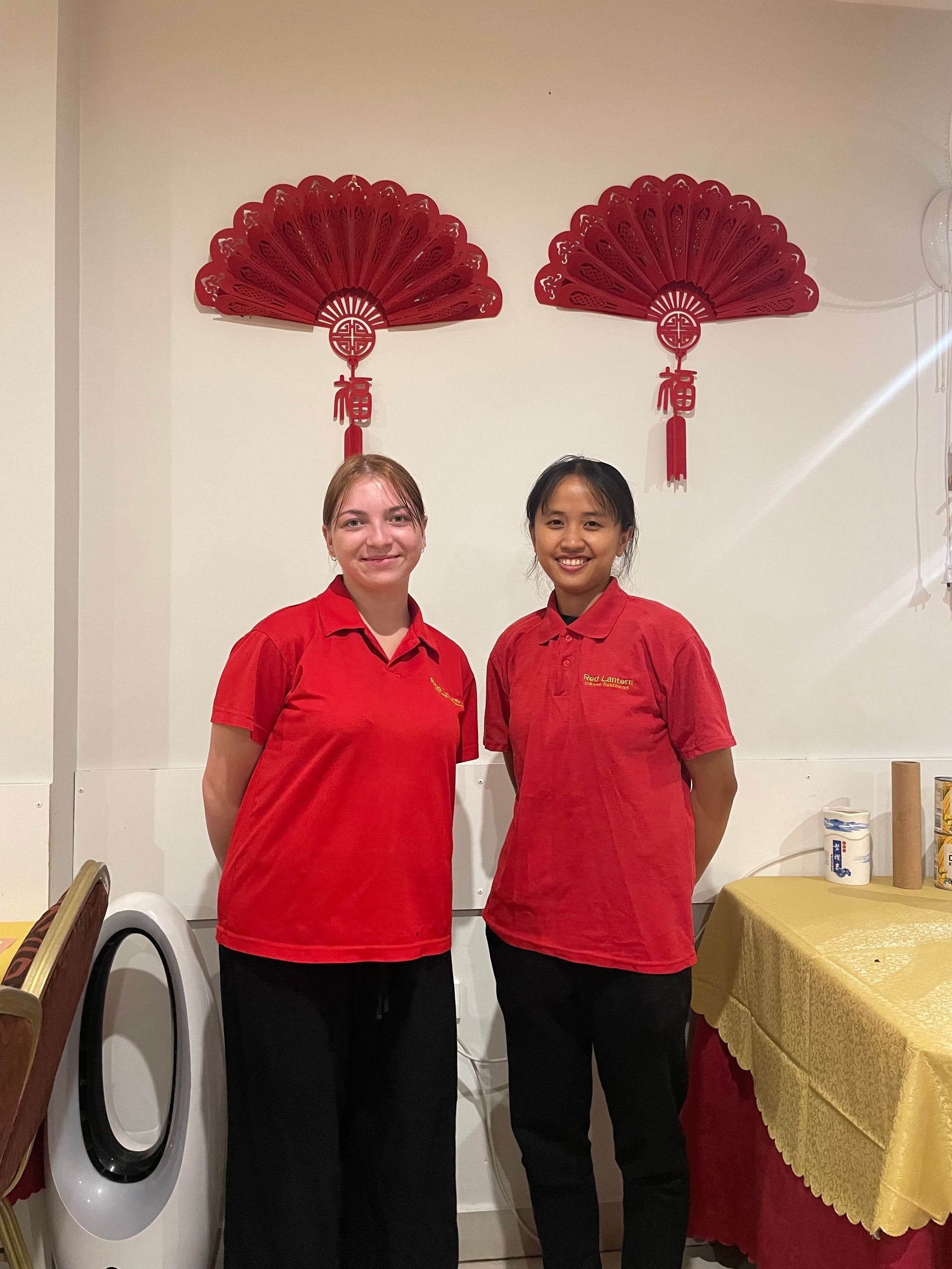 A Group of Women in Red Shirts Are Posing for a Picture in a Restaurant — Red Lantern Chinese Restaurant In Palmerston City, NT