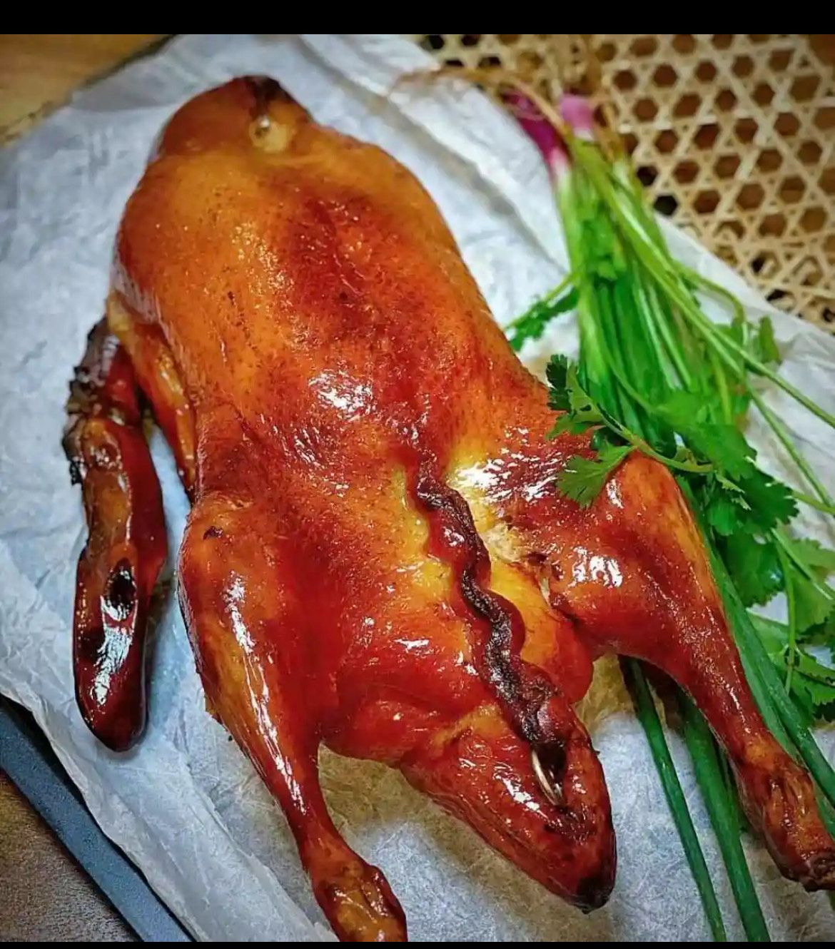 A cooked chicken on a plate with herbs — Red Lantern Chinese Restaurant In Palmerston City, NT