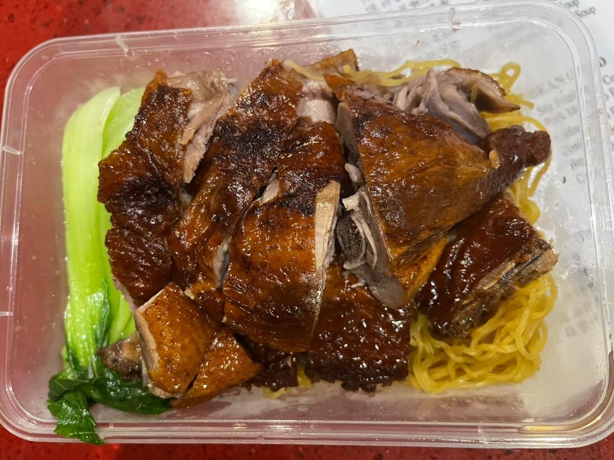 A Plastic Container Filled With Noodles and Meat on a Table — Red Lantern Chinese Restaurant In Palmerston City, NT