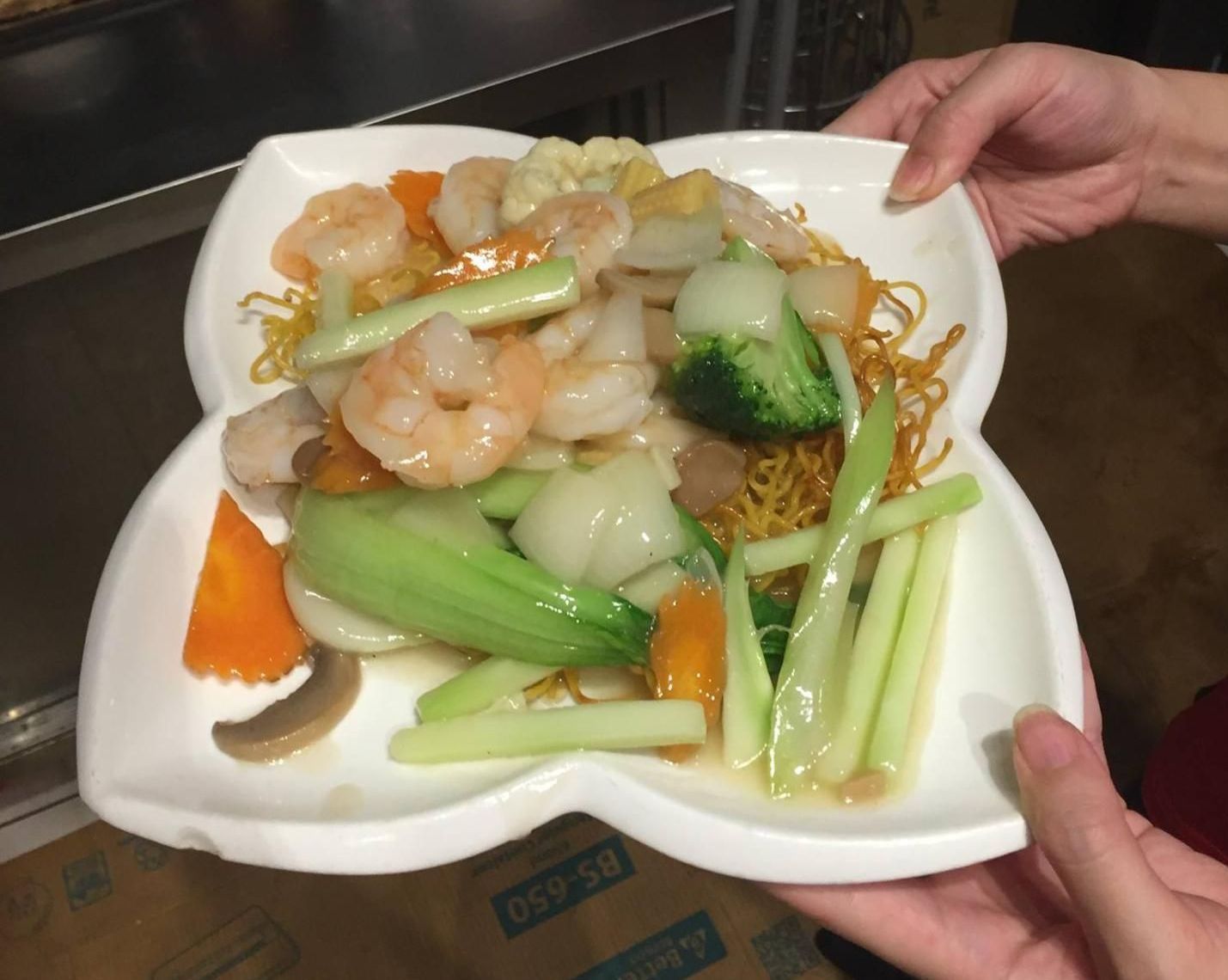 A Person is Holding a Plate of Food With Shrimp and Vegetables — Red Lantern Chinese Restaurant In Palmerston City, NT