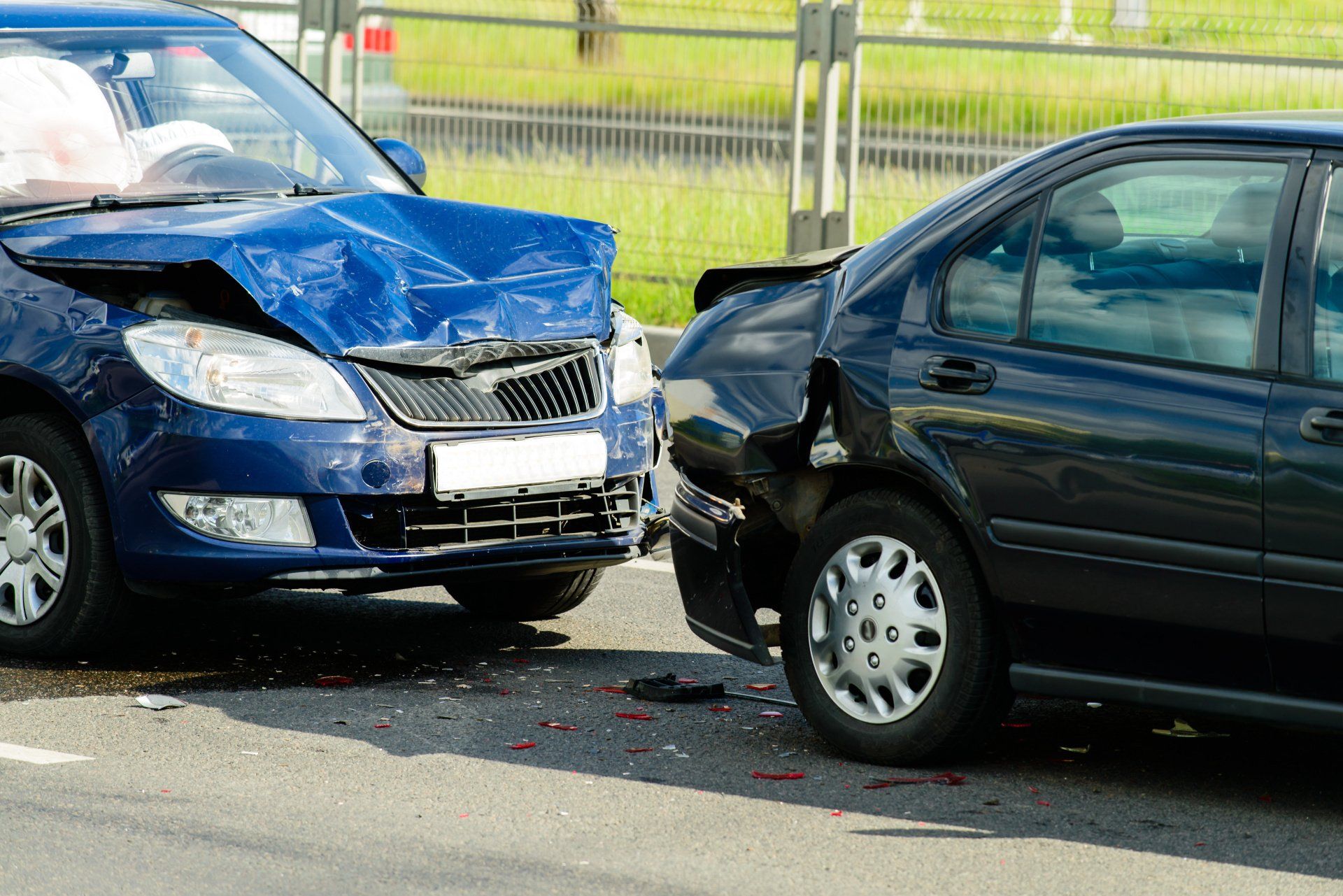 blue car and black car accident