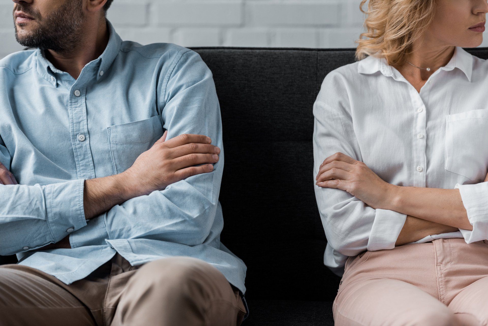 couple angry sitting on couch after asking for divorce