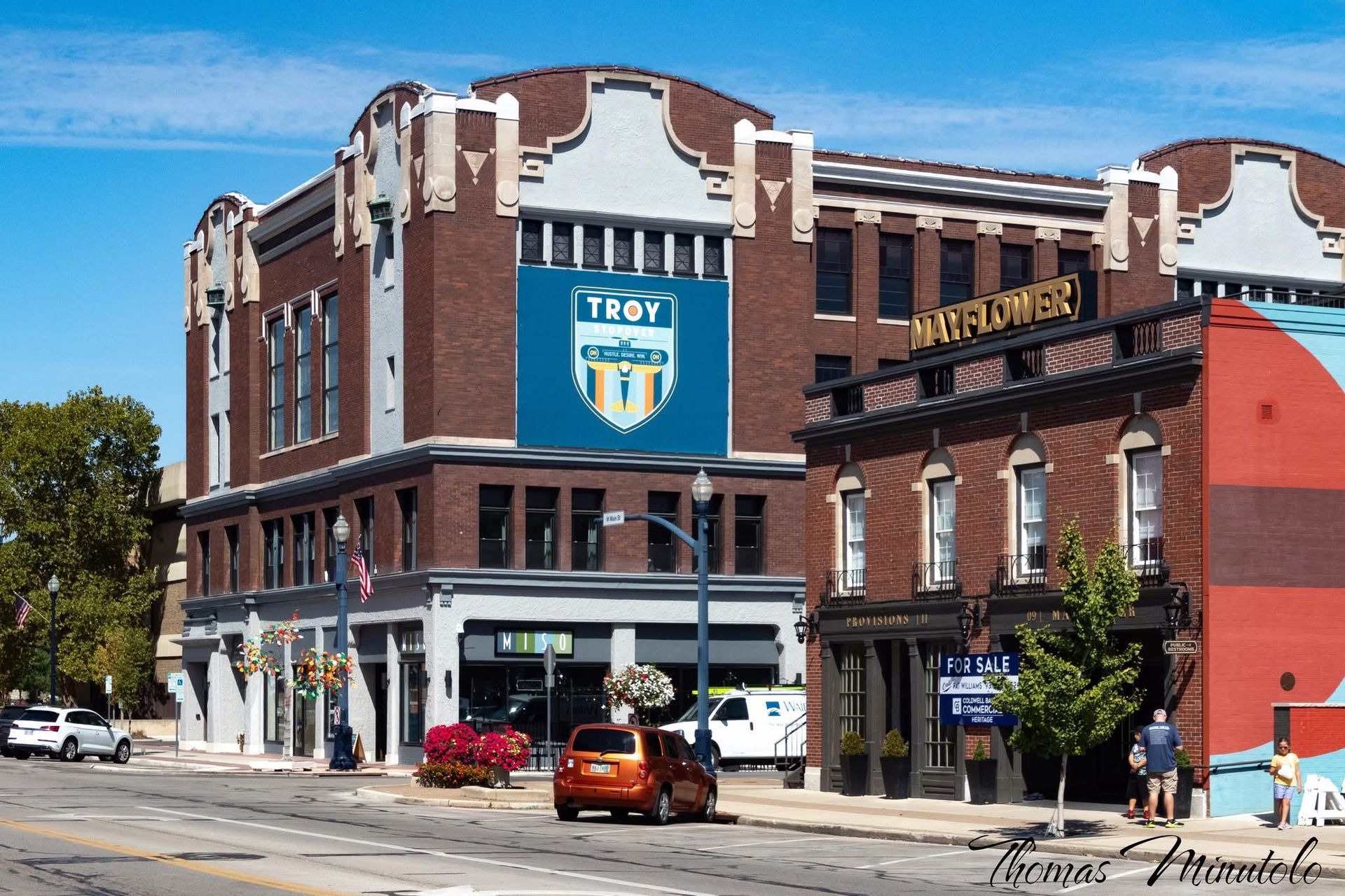 White orchids in full bloom against a dark green background.
