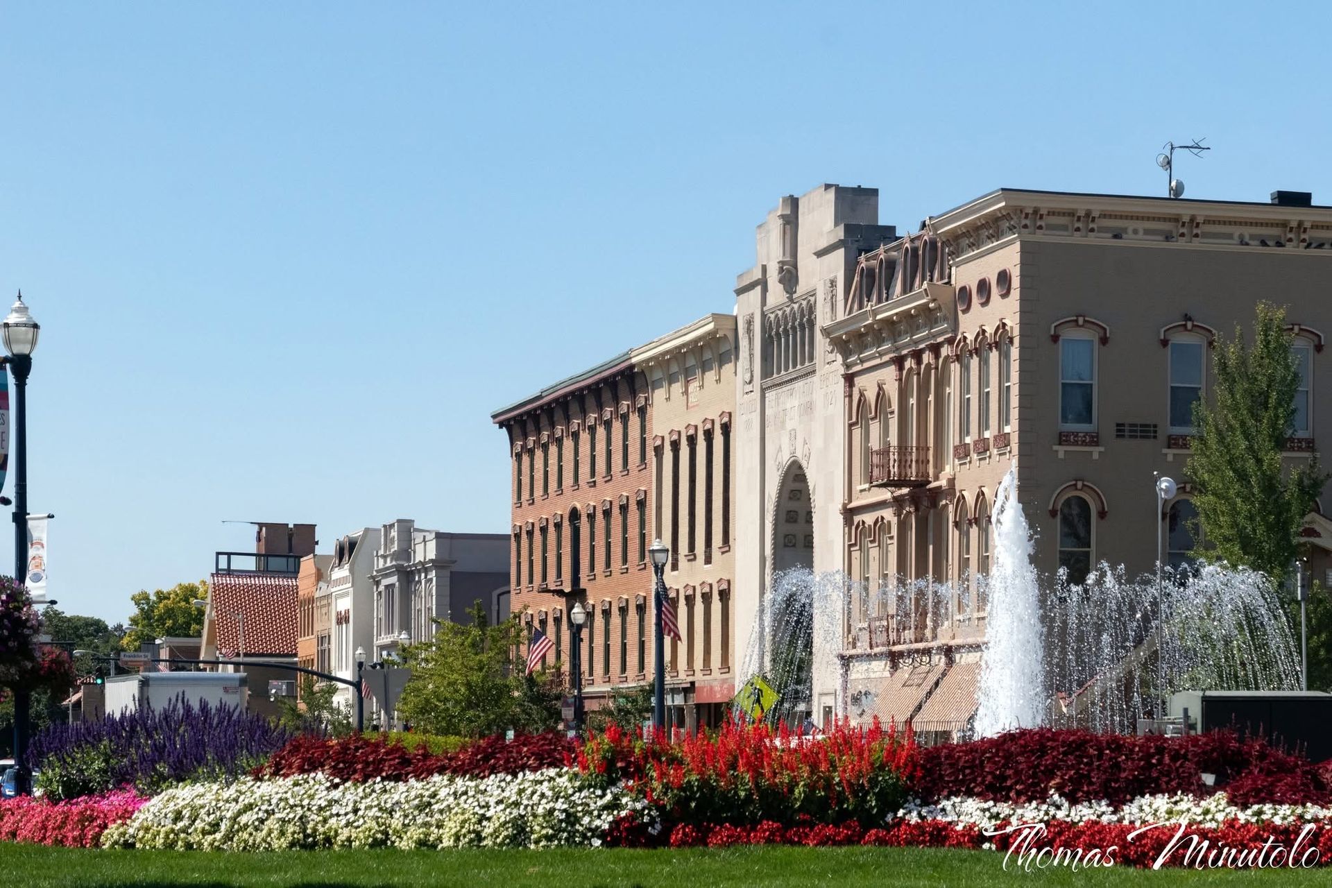 Tranquil sunset over a lake, with trees silhouetted against the sky, reflecting in the water.