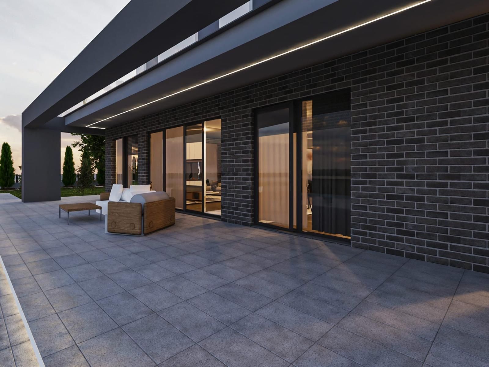 Ein großes Backsteingebäude mit einer Terrasse davor