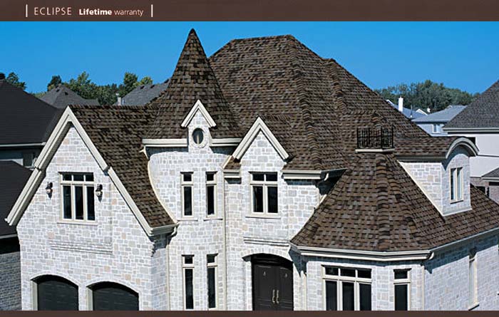A large white brick house with a brown roof