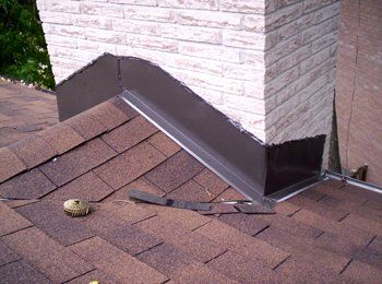 Un toit avec des bardeaux et une cheminée dessus