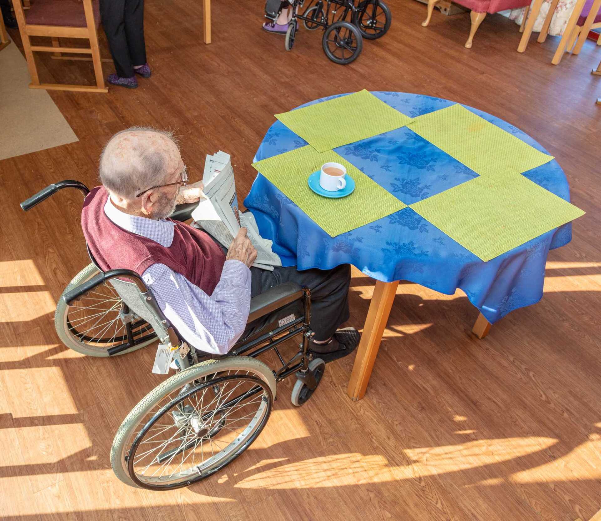 man in a wheelchair at a table