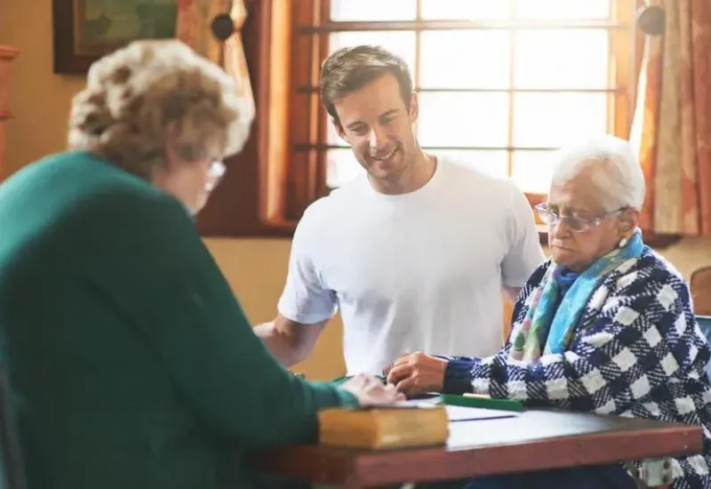 A smiling Activities Coordinator in a vibrant community setting, representing career opportunities in recreation and activity programming within independent and assisted living residences in Montreal, St-Grégoire, and St-Charles-Borromée.