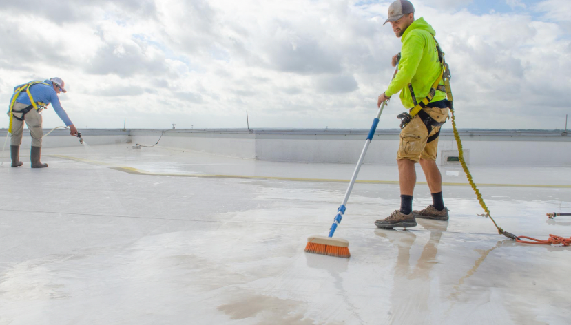 A group of construction workers are working on a road.