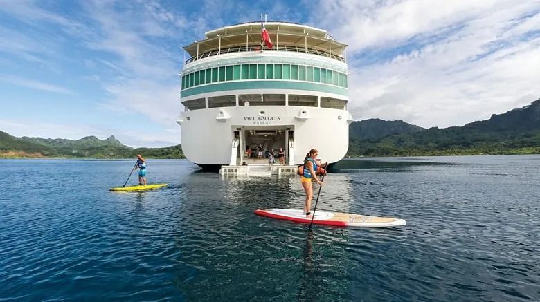 Person handing over a passport and tickets at a desk; small airplane model and payment device visible.