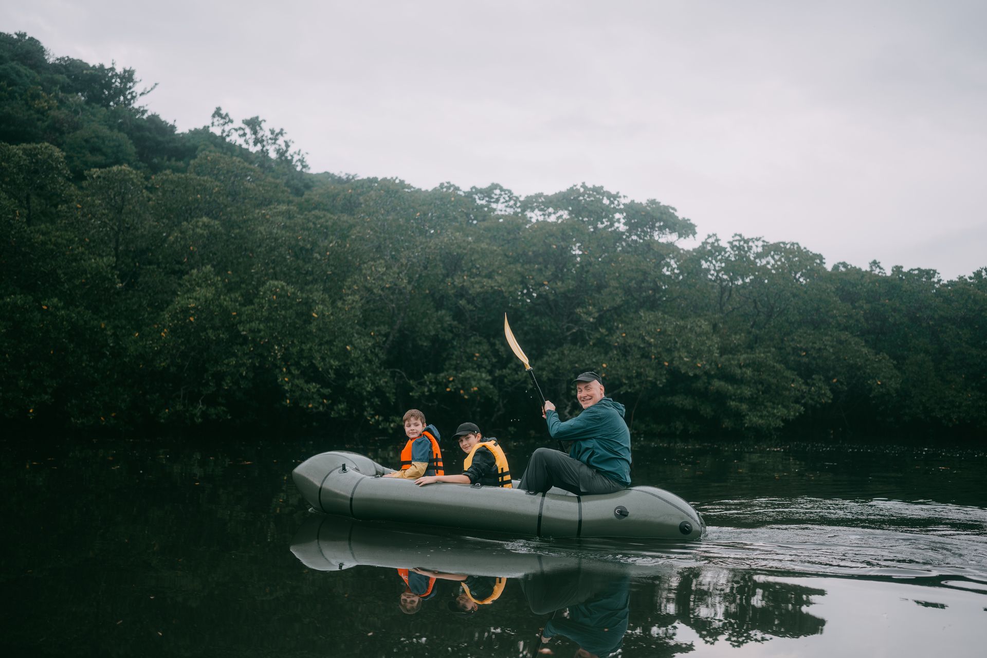 Cruise ship on a turquoise ocean near a sandy beach with palm trees under a blue sky.