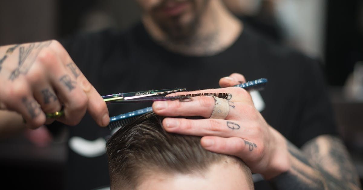 A man is getting his hair cut by a barber in a barber shop.