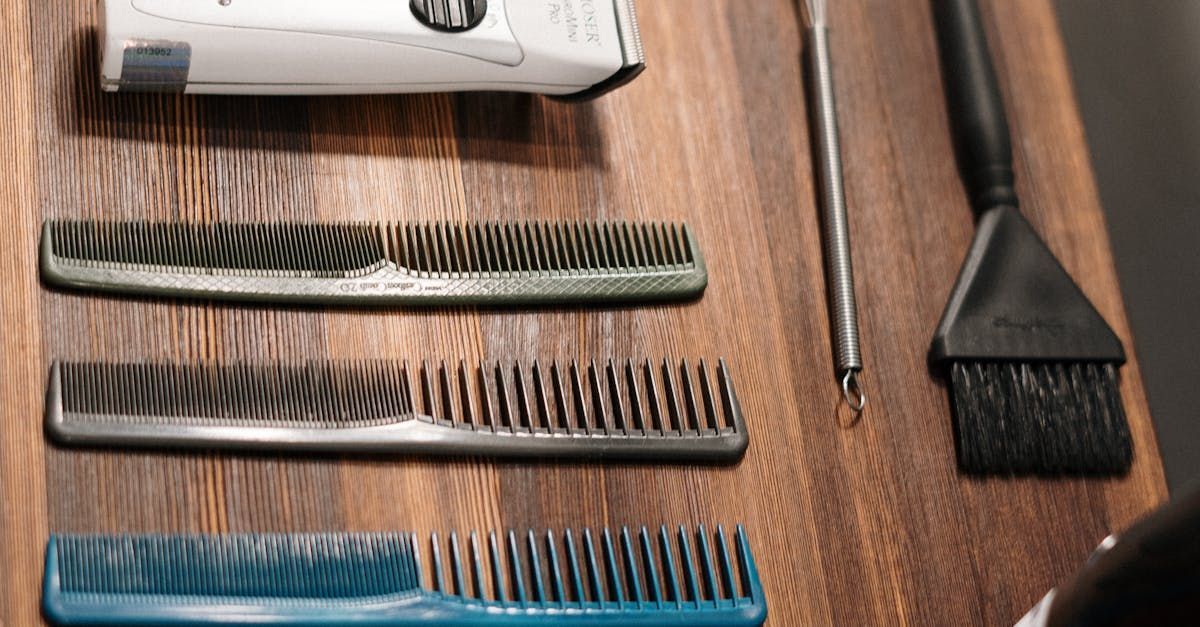 A man with a beard is holding a tattoo machine in his hands