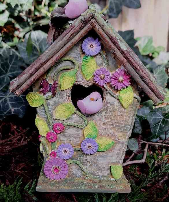 Birdhouse decorated with clay and acrylic paint