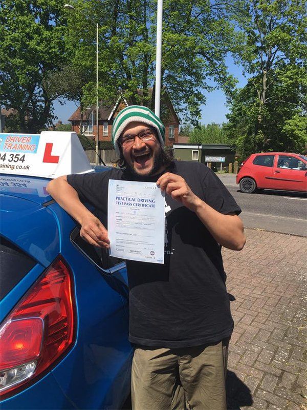 a man smiling with the certificate