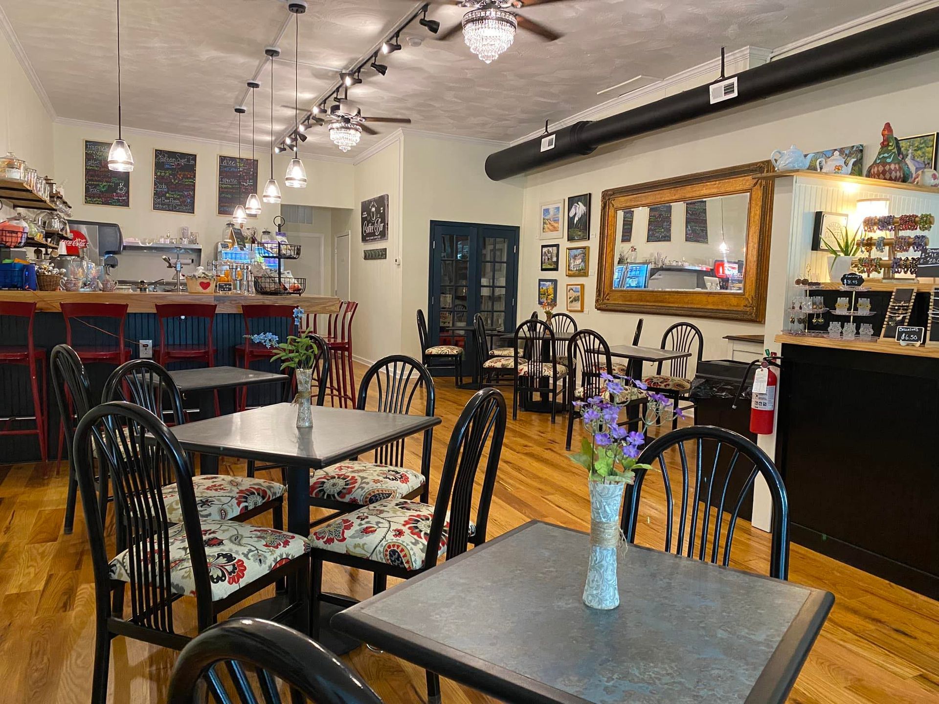 A store front with rocking chairs in front of it.