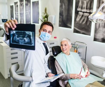 Dentist Checking His Patient's Dental X-Ray — Munster, IN — Michael Perez DDS, PC