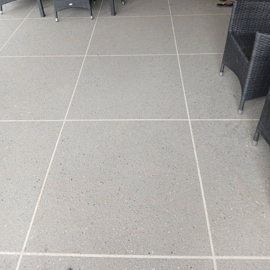 A Tiled Floor With Chairs and Tables on It — Troys Concrete Overlays in Hillcrest, QLD