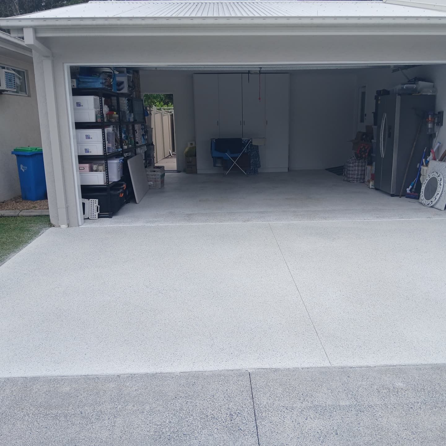A new Drive way infront of a garage — Troys Concrete Overlays in Hillcrest, QLD
