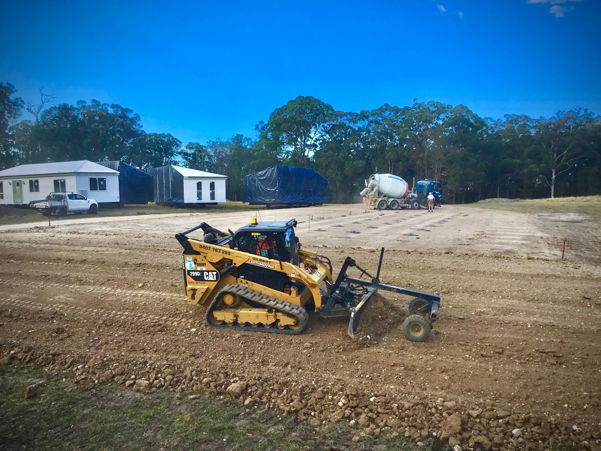 A Large Body of Water is Surrounded by Trees and Grass — S M & A J Gilbert Earthmoving in Mitchells Island, NSW
