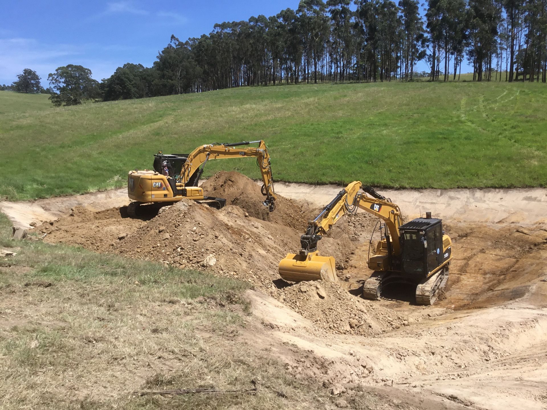 A Bulldozer is Digging a Pile of Dirt in a Field — S M & A J Gilbert Earthmoving in Gloucester Island, NSW