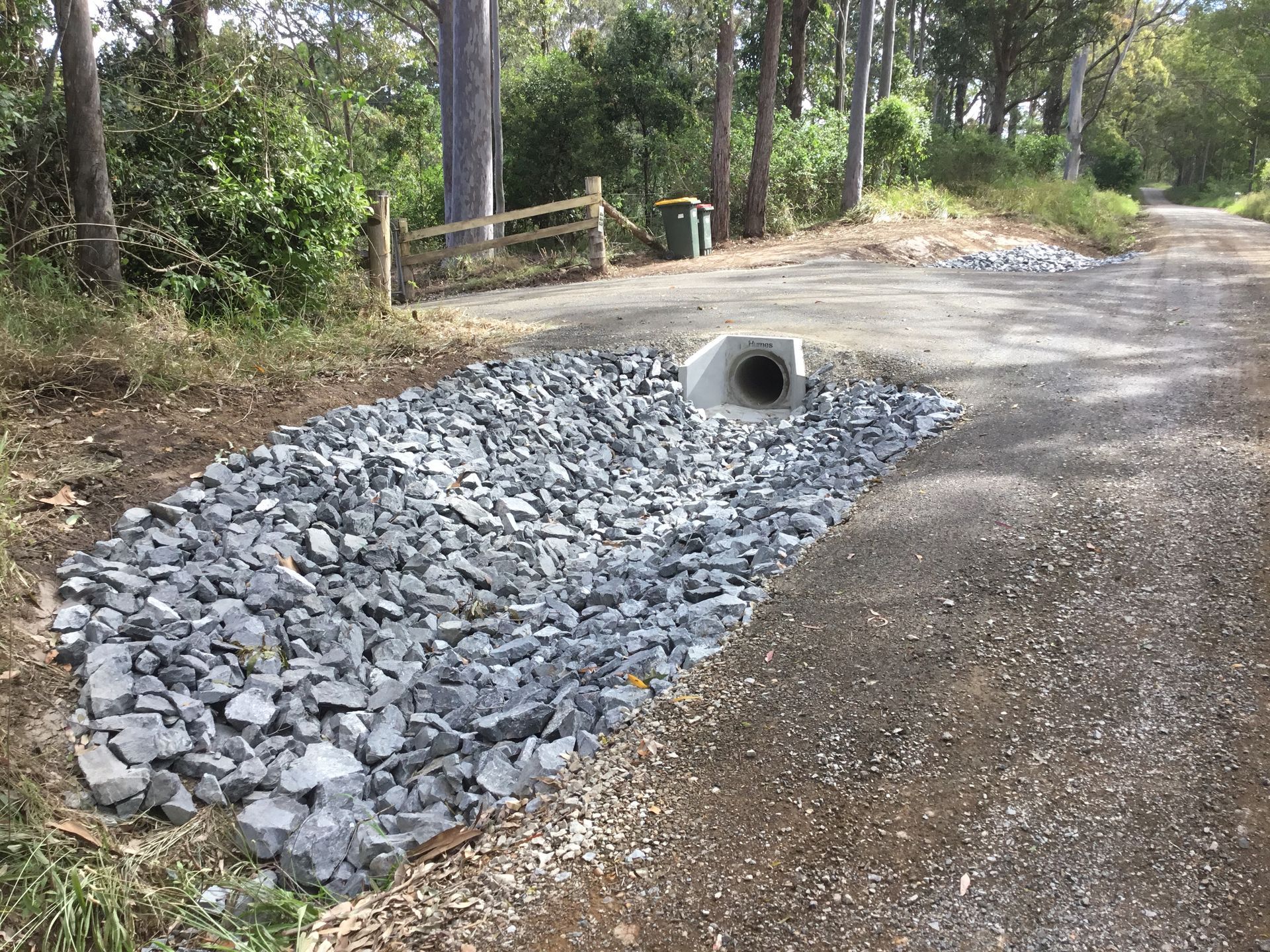 Gravel-covered Drainage Culvert on a Dirt Road, Leading Into a Concrete Pipe — S M & A J Gilbert Earthmoving in Mitchells Island, NSW
