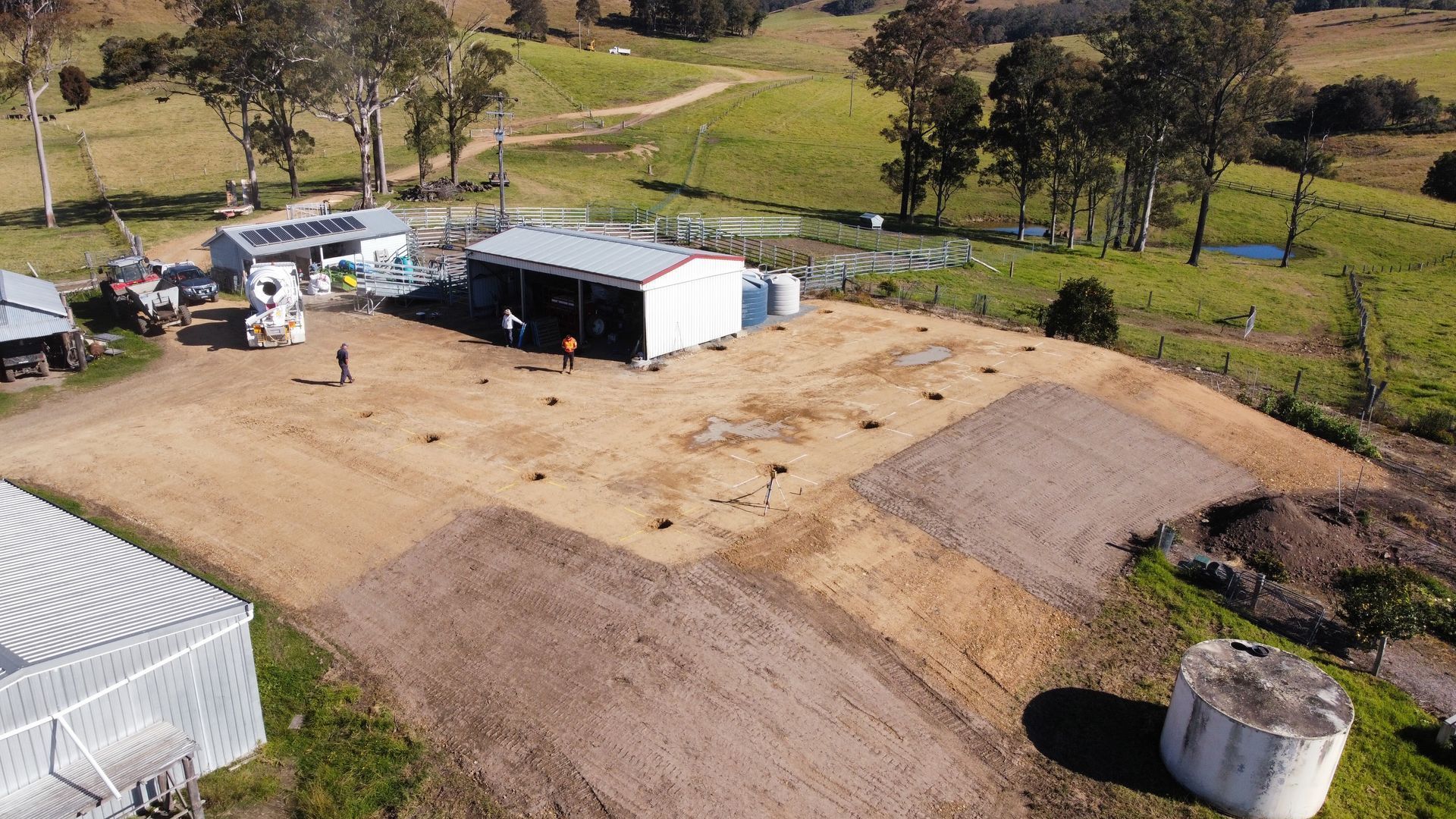 A House With a White Roof is Sitting on Top of a Dirt Road — S M & A J Gilbert Earthmoving in Mitchells Island, NSW