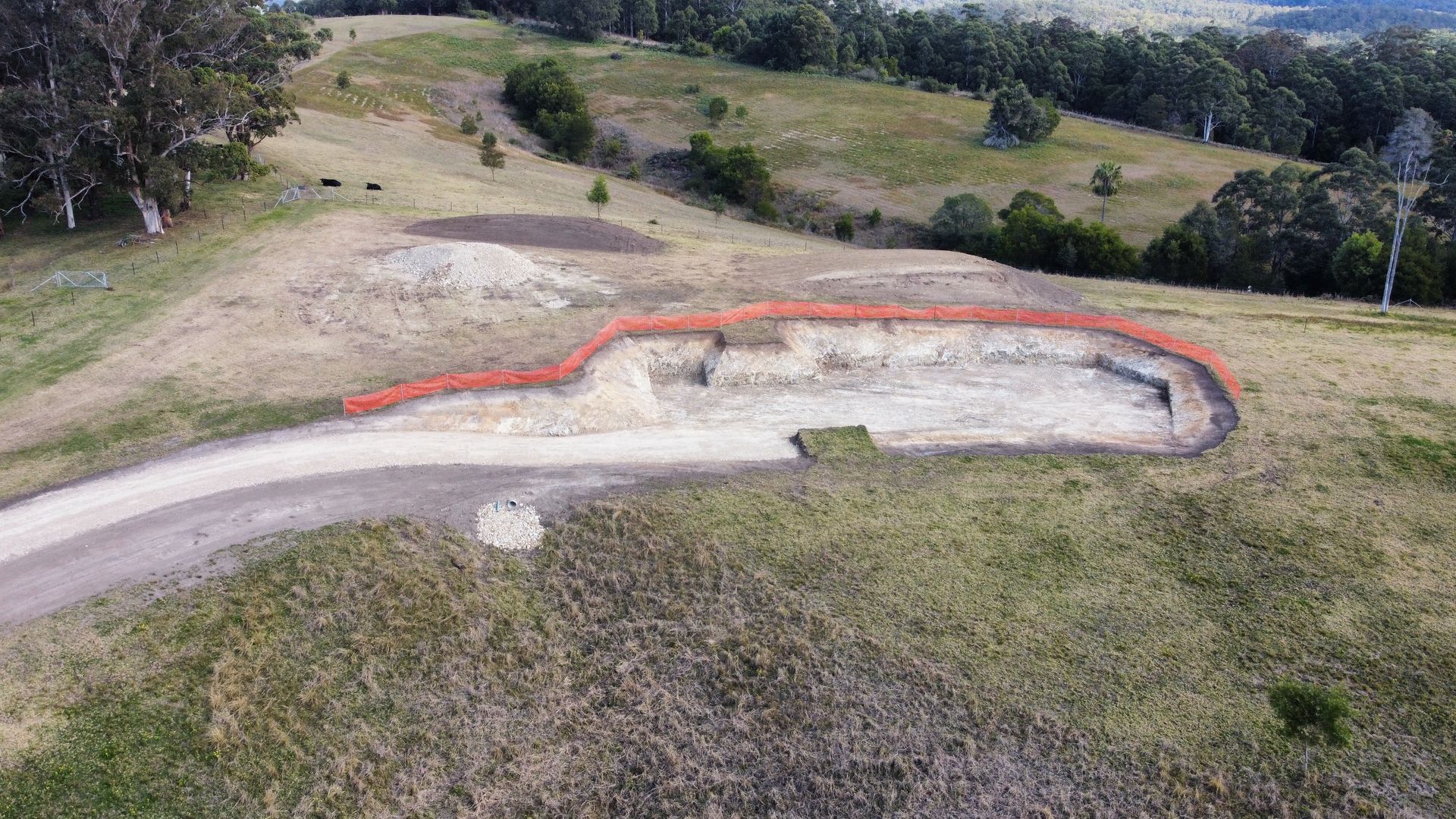 Aerial View of a Construction Site Cut Into a Hillside, Outlined in Red — S M & A J Gilbert Earthmoving in Mitchells Island, NSW