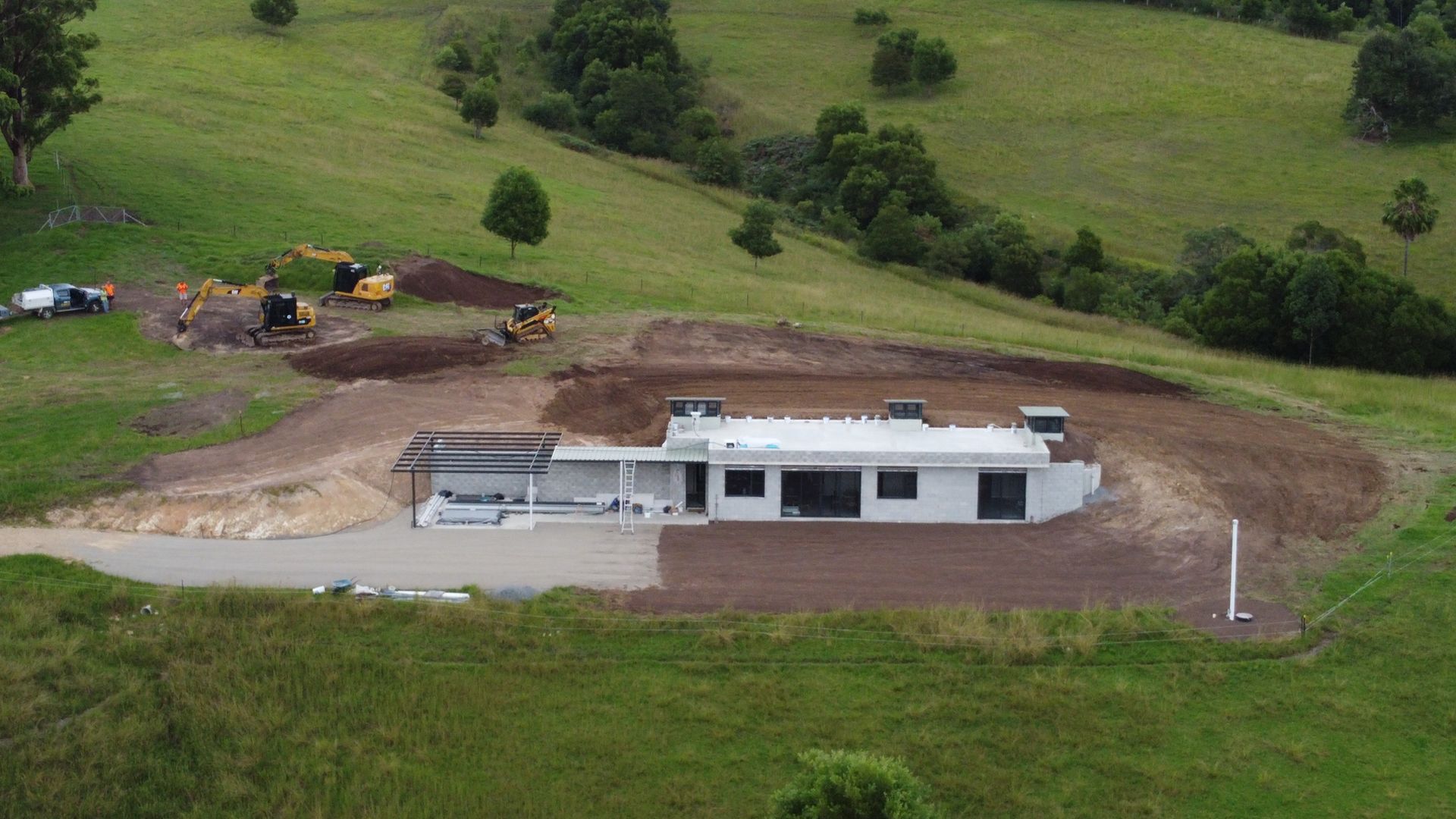 A Modern White House Under Construction on a Grassy Hill — S M & A J Gilbert Earthmoving in Mitchells Island, NSW